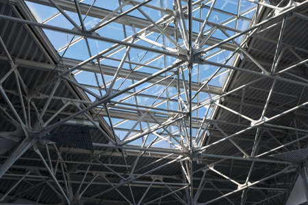 Structural steels with window in ceiling with blue sky, close up viewの写真素材