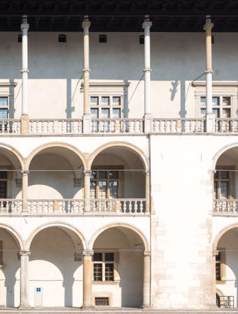 White building with arched shape balconies and pillarsの写真素材