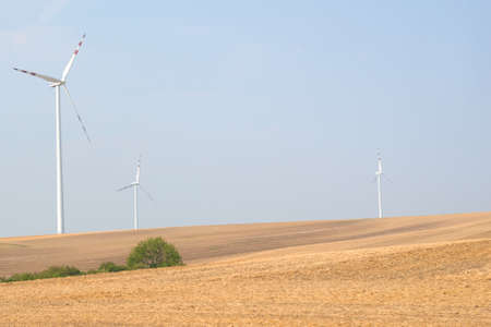 Landscape view with fields and wind power stations