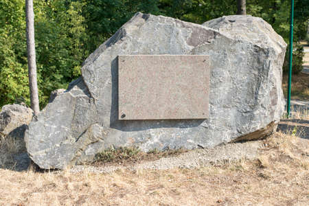 Stone with empty sign and trees backgroundの写真素材