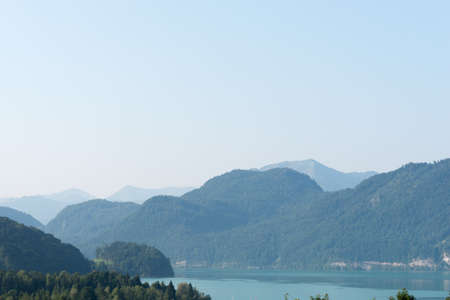 Green hills view with lake and blue skyの写真素材