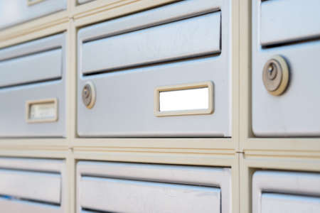 Letter boxes with key holes, close up viewの写真素材