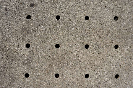 Holes in gray wall, texture background. Close up viewの写真素材