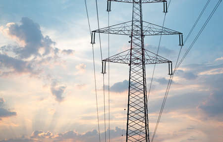 Electric poles with sun and blues ky background