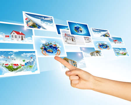 Humans hand with holographic pictures on abstract backgroundの写真素材