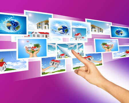 Womans hand and with holographic pictures on abstract backgroundの写真素材