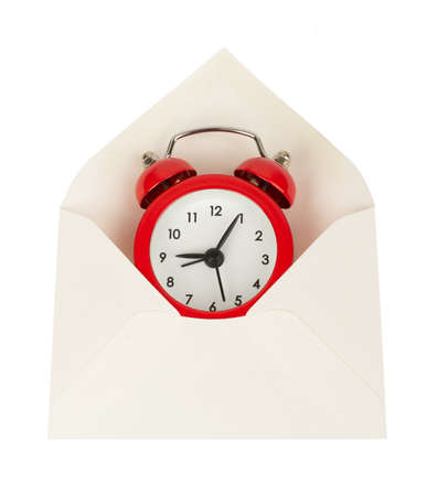 Open white envelope with alarm clock on isolated white background, close up viewの写真素材