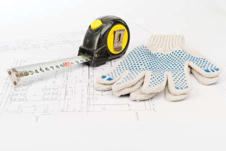 Tape measure with gloves on draft backgroundの写真素材