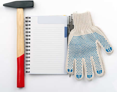 Copybook with hammer on isolated white background, top view