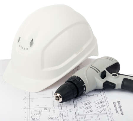 Grey electric screwdriver with helmet on draft, close up view