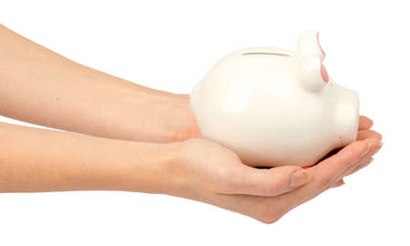 Pigggy bank in humans hands on isolated white background, side viewの写真素材
