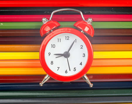 Alarm clock on crayons, close up viewの写真素材