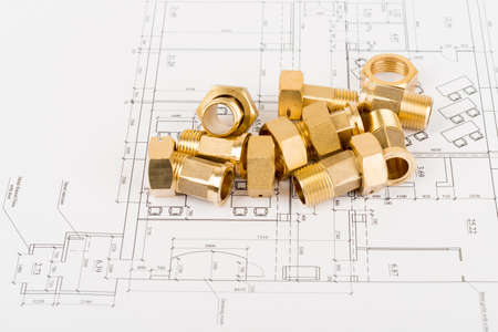 Metal pipe fittings on draft background, close up view