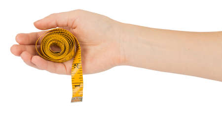 Humans arm holding tape measure on isolated white backgroundの写真素材