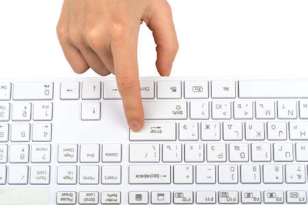 Humans finger pressing on keyboard button on isolated white background