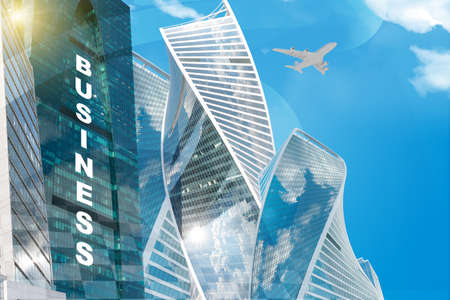 Business center with world map and business word on blue sky backgroundの写真素材