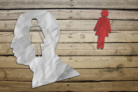 Paper people symbols on wood deck backgroundの写真素材