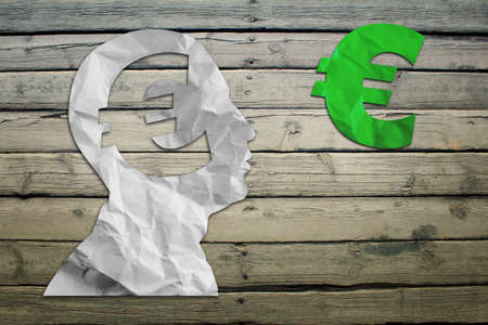 Paper humans head with euro symbol on wood deck backgroundの写真素材