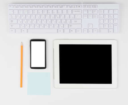Keyboard with tablet and smartphone on isolated white background