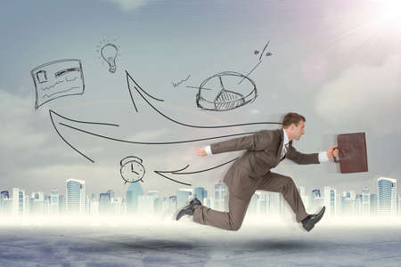 Businessman running fast with suitcase on abstract backgroundの写真素材