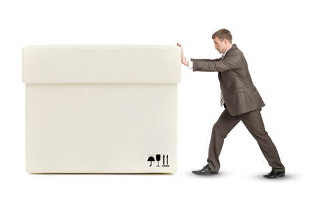 Businessman pushing big white box on isolated white backgroundの写真素材