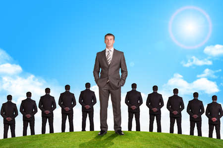 Set of businessmen on nature background with green grass and blue skyの写真素材
