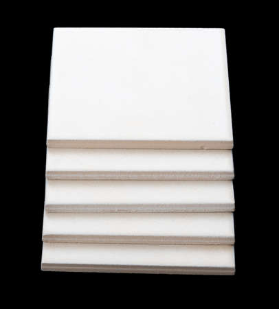 Pile of tiles on black backround, side viewの写真素材