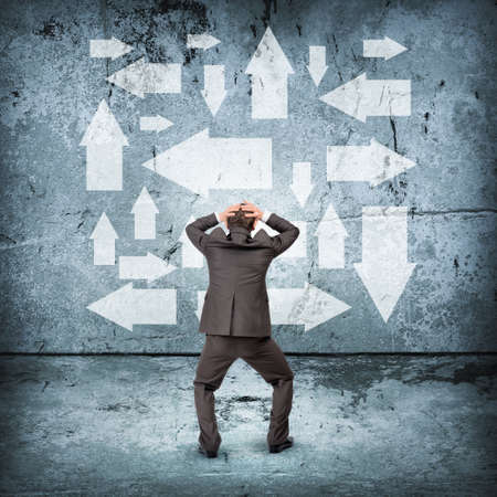 Businessman in front of different ways, rear viewの写真素材