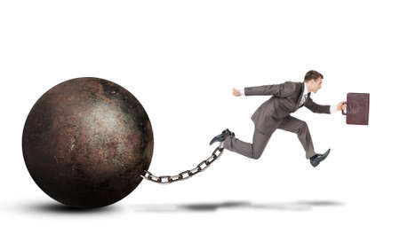 Image of young businessman with suitcase and iron ballast jumping over gap on isolated white backgroundの写真素材