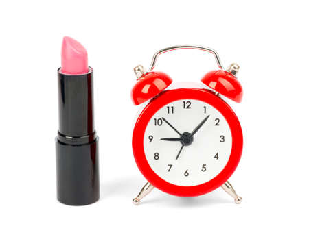 Morning of woman with lipstick and alarm clock on whiteの写真素材