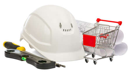 White construction helmet, builders level and shopping cart on isolated white backgroundの写真素材