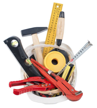 Construction worker supplies including  white hard hat on isolated white background, top view