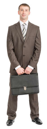 Businessman standing with suitcase and looking at camera on isolated white background, front viewの写真素材
