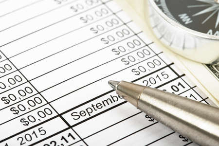 Compass with pen on bills background, closeup