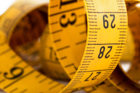 Measuring tape of tailor isolated on white background, closeupの写真素材