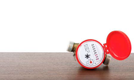 Red water meter on table isolated on white background