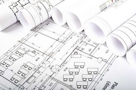 Architectural blueprint and blueprint rolls, side view