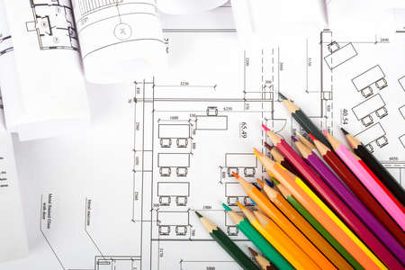 Crayons on blueprint and blueprint rolls backgroundの写真素材
