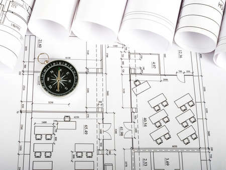 Compass on blueprint and blueprint rolls backgroundの写真素材
