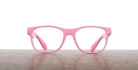 Pair of pink eyeglasses on table isolated on white background, closeupの写真素材