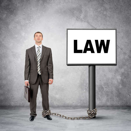 Businessman word law on post sign with chainの写真素材