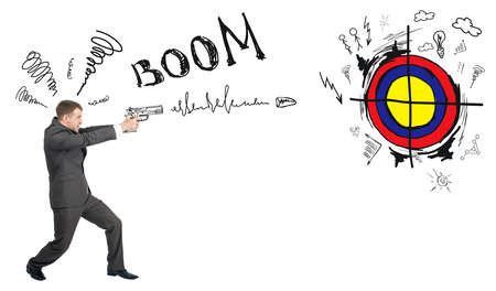 Businessman shooting from gun to darts with word boom isolated on white background, goal conceptの写真素材