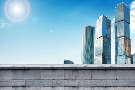 Skyscrapers with grey wall and blue sky, business conceptの写真素材