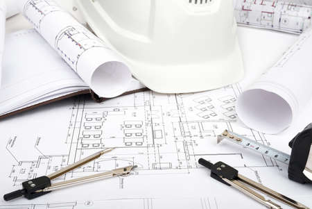 Architecture plan and rolls of blueprints with meter and helmet. Building conceptの写真素材