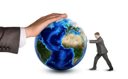 Businessman pushing earth globe against big hand isolated on white background. Elements of this...
