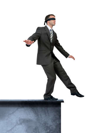 Businessman with band on eyes standing on edge isolated on white background, danger concept