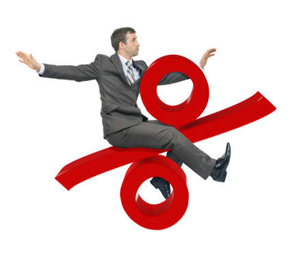 Businessman riding percent sign isolated on white backgroundの写真素材