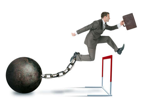 Businessman with iron ball hoppig over barrier isolated on white background, competition conceptの写真素材