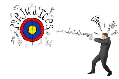 Businessman shooting from gun to darts with word prejudice isolated on white background, goal conceptの写真素材