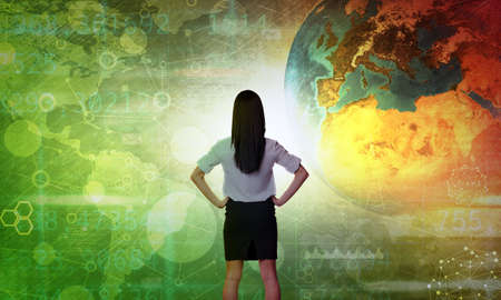 Business woman in front of holographic screen with earth globe.の写真素材